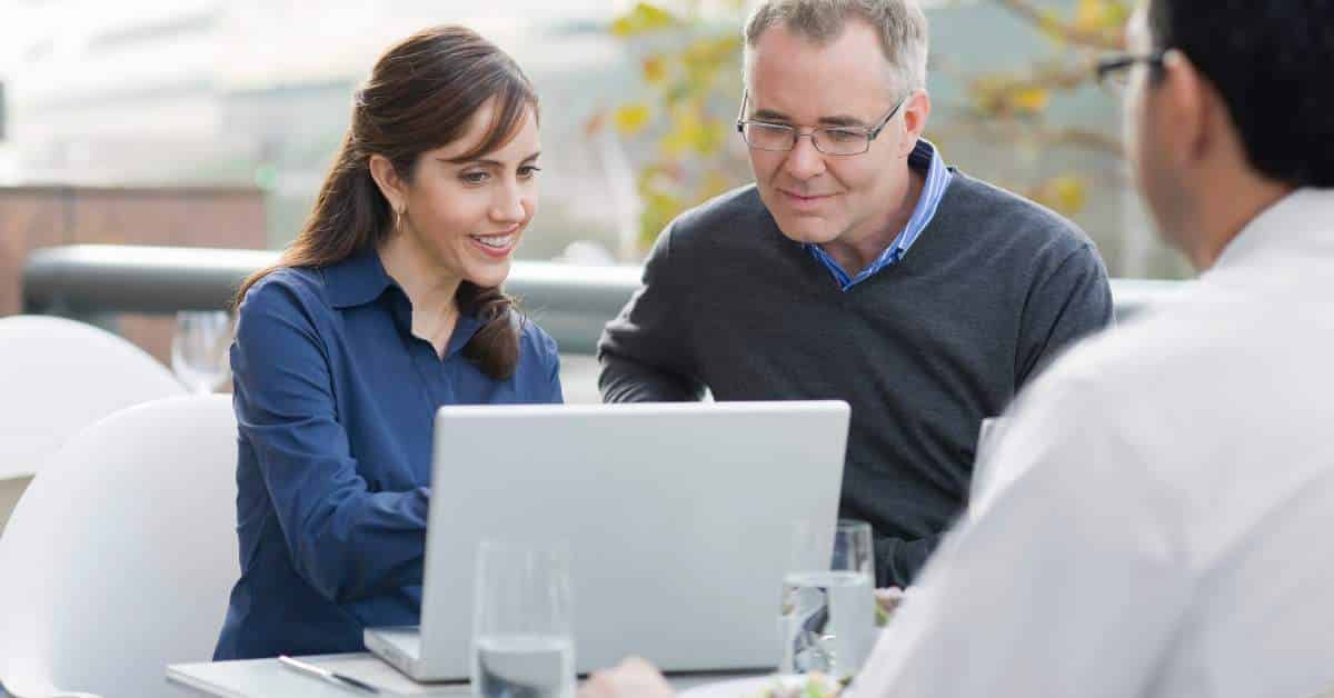 Woman and Man Looking at a Computer with woman explaining something to the man