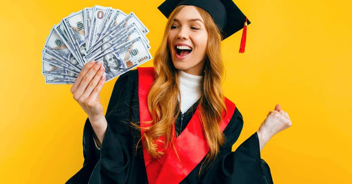 Young woman in a graduation cap and gown holding a diploma in one hand and a fan of $100 bills in the other.