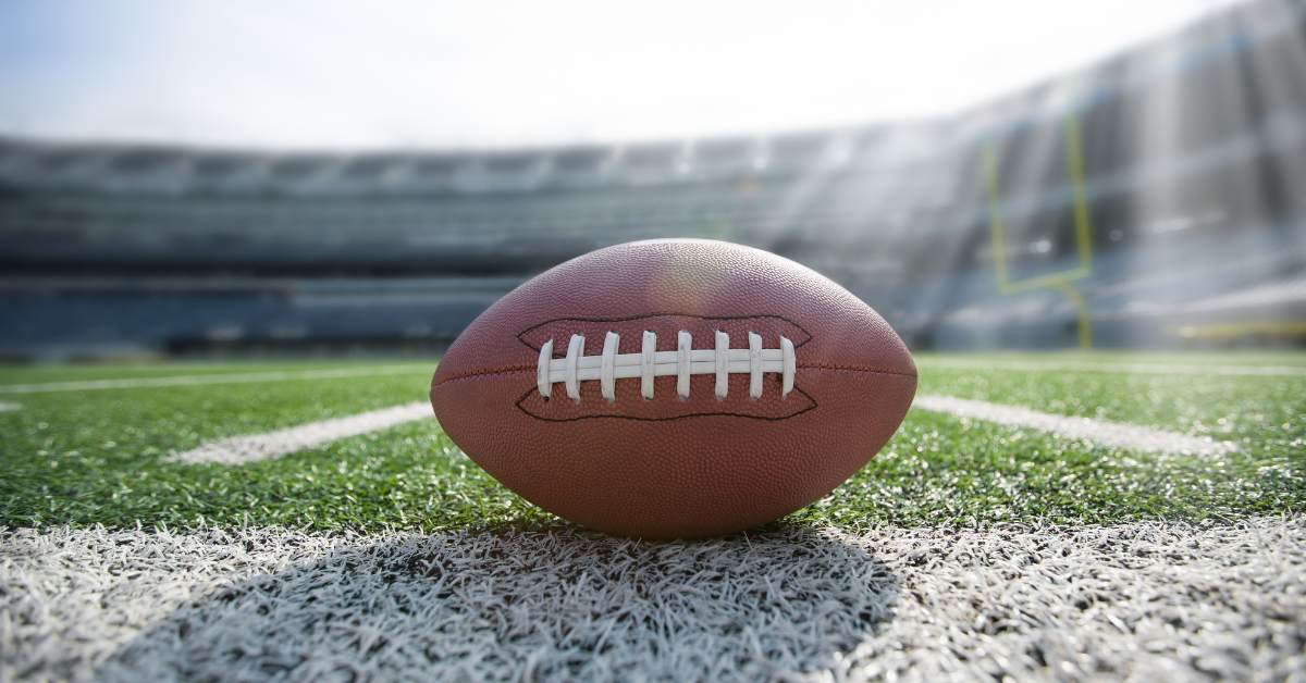 Picture of a football on a football field.
