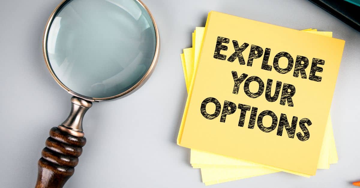 Magnifying glass with post-it note saying explore your options
