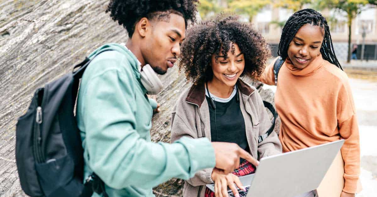 Three African American Students Looking at a Computer