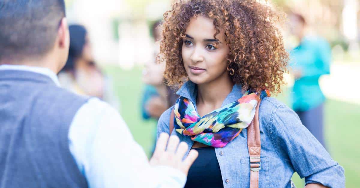 Woman listening intently to a man speaking.