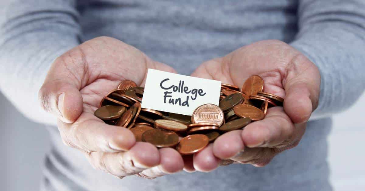 Person with Hands wide open and holding a pile of pennies with "college fund" written on a piece of paper