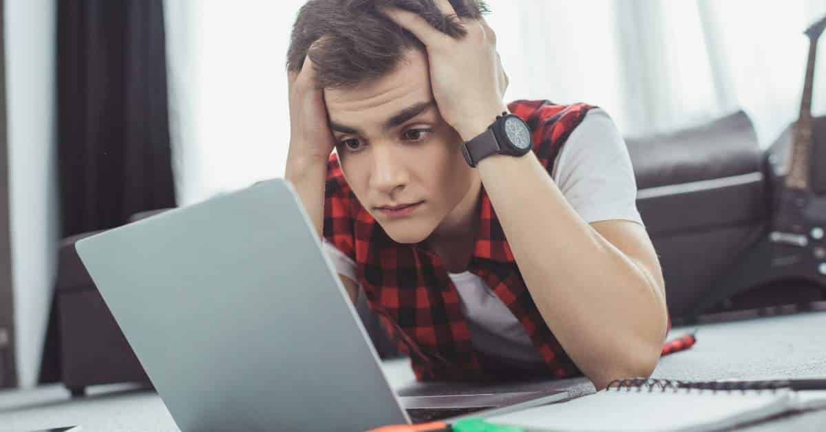 Stressed Teen Holding His Head in His Hands while Staring at the Computer