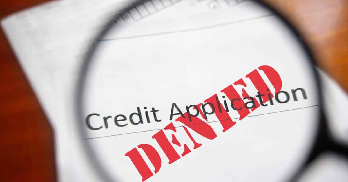 White Piece of Paper that Says, "Credit Application" with the word "Denied" written in red on top of it.