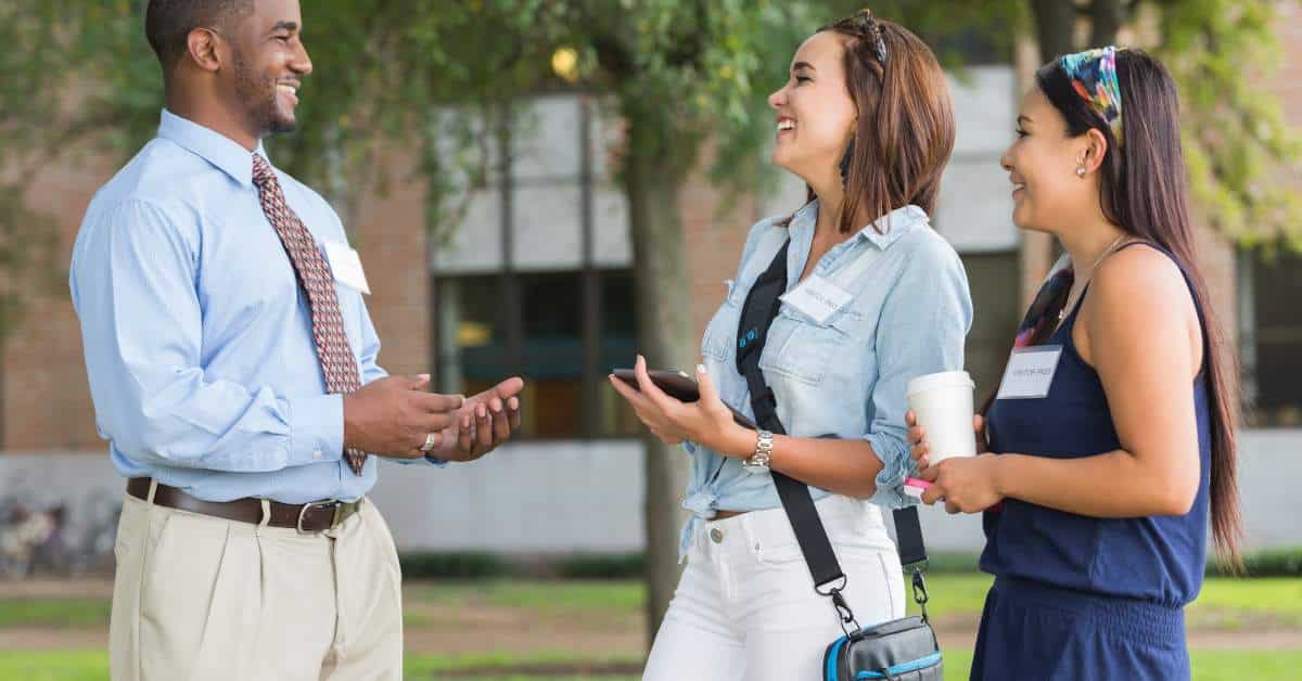 Two women talking to a college tour guide