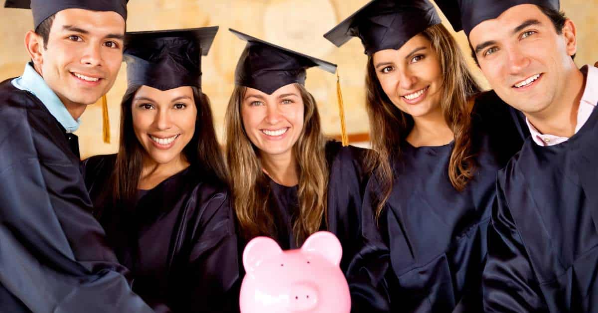 Five students in cap and gown each supporting a pink piggy bank.